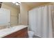 Well-lit bathroom with a shower/tub, tile surround, wood vanity, and neutral walls at 1086 Mockingbird St, Brighton, CO 80601