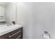 Modern half bathroom featuring a floating vanity with a white countertop and wood-look cabinets at 1086 Mockingbird St, Brighton, CO 80601