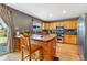 Bright kitchen with wood cabinets, stainless appliances, and an eat-in kitchen island at 1086 Mockingbird St, Brighton, CO 80601