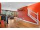 Spacious living area with hardwood floors, stairs to second level, and rustic accent wall at 1086 Mockingbird St, Brighton, CO 80601