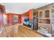 Bright living room with wood floors, a rustic wood accent wall and natural light at 1086 Mockingbird St, Brighton, CO 80601