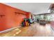 Bright living area with hardwood floors, a rustic wood accent wall, and a view of the yard at 1086 Mockingbird St, Brighton, CO 80601