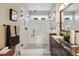Bathroom with glass enclosed shower, double shower head, sink and decorative towels at 3698 Penang Dr, Castle Rock, CO 80109