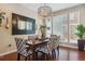 Dining room with wooden table, decorative chairs, large window, and chandelier at 3698 Penang Dr, Castle Rock, CO 80109