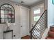 Bright entryway features modern staircase, stylish mirror and decor, creating an inviting first impression at 3698 Penang Dr, Castle Rock, CO 80109