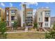 Contemporary townhomes featuring modern architecture, landscaping, and a well-maintained green space for curb appeal at 3698 Penang Dr, Castle Rock, CO 80109
