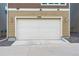 A two-car garage providing ample parking and storage, with exterior lighting and a well-maintained facade at 3698 Penang Dr, Castle Rock, CO 80109