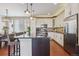 Modern kitchen with stainless steel appliances, granite countertops, and breakfast bar at 3698 Penang Dr, Castle Rock, CO 80109