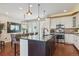 Well-lit kitchen with stainless appliances, granite countertops, and ample storage space at 3698 Penang Dr, Castle Rock, CO 80109