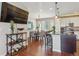 Open-concept living space with hardwood floors, modern lighting, and a dining area at 3698 Penang Dr, Castle Rock, CO 80109