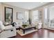Bright living room boasts modern decor, hardwood floors, and large windows offering natural light and outdoor views at 3698 Penang Dr, Castle Rock, CO 80109