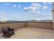 Outdoor rooftop patio with comfortable seating and stunning views of the mountains and city skyline at 3698 Penang Dr, Castle Rock, CO 80109