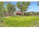 Expansive backyard with mature trees and green grass, ideal for outdoor activities at 1697 W Powers Ave, Littleton, CO 80120