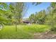 Well-manicured backyard with lush green grass and landscaping and detached structure at 1697 W Powers Ave, Littleton, CO 80120