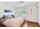 Bedroom with hardwood floors, neutral walls, ceiling fan, and window with natural light at 1697 W Powers Ave, Littleton, CO 80120
