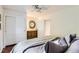 Bedroom featuring hardwood floors, a double-door closet, and access to an en suite bathroom at 1697 W Powers Ave, Littleton, CO 80120