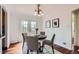 Cozy dining room featuring a round table with four chairs, hardwood floors, and a door to the backyard at 1697 W Powers Ave, Littleton, CO 80120