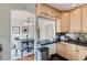 Bright dining area next to the kitchen, featuring a dark wood table and seating for four at 1697 W Powers Ave, Littleton, CO 80120
