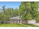 Charming single-story home with mature trees, manicured lawn, and attached garage, with inviting curb appeal at 1697 W Powers Ave, Littleton, CO 80120