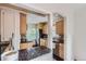 A view of the kitchen with wooden cabinets, granite countertops, stainless steel appliances, and tile backsplash at 1697 W Powers Ave, Littleton, CO 80120