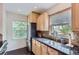 Kitchen showcasing a stainless steel refrigerator, granite countertops, and natural light at 1697 W Powers Ave, Littleton, CO 80120