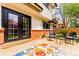 Charming back patio with brick foundation, seating, and french doors to the home at 8736 E Easter Ave, Centennial, CO 80112