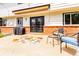Comfortable back patio with stylish outdoor seating, grill, and french door access to the home at 8736 E Easter Ave, Centennial, CO 80112