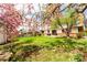 Lush backyard featuring mature trees, green lawn, and access to a brick patio at 8736 E Easter Ave, Centennial, CO 80112