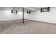 Spacious finished basement with cozy carpet, white walls, and natural light from window at 8736 E Easter Ave, Centennial, CO 80112