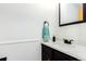 Stylish half bathroom features a dark vanity, modern fixtures, and white countertop at 8736 E Easter Ave, Centennial, CO 80112
