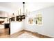 Dining room with natural light, wood floors, modern chandelier, and a view of the backyard at 8736 E Easter Ave, Centennial, CO 80112