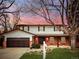 Charming two-story home with a brick facade and a well-manicured front yard at 8736 E Easter Ave, Centennial, CO 80112
