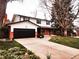 Charming two-story home with a brick facade and a well-manicured front yard at 8736 E Easter Ave, Centennial, CO 80112