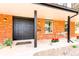 Inviting brick front porch with a double door entry, adorned with flowers and a small table at 8736 E Easter Ave, Centennial, CO 80112