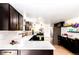 Modern kitchen with white counters, dark cabinets, stainless steel appliances, and floating shelves at 8736 E Easter Ave, Centennial, CO 80112