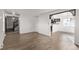 Bright living room featuring wood floors and an open floorplan leading to the staircase and kitchen at 8736 E Easter Ave, Centennial, CO 80112