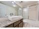 Bathroom with granite countertop vanity and a shower/tub combo at 6702 S Ivy Way # A1, Centennial, CO 80112