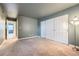 Bedroom with neutral walls, carpeting, and lots of closet space at 6702 S Ivy Way # A1, Centennial, CO 80112