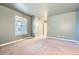 Bright bedroom with window, carpet, and access to bathroom at 6702 S Ivy Way # A1, Centennial, CO 80112