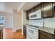 View of kitchen with granite countertops and microwave at 6702 S Ivy Way # A1, Centennial, CO 80112