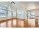 Vaulted ceiling living room with hardwood floors, fireplace and doors to patio at 6702 S Ivy Way # A1, Centennial, CO 80112