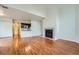 Open living space with hardwood floors, kitchen, and fireplace at 6702 S Ivy Way # A1, Centennial, CO 80112