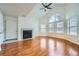 Hardwood floor living room with fireplace and access to kitchen at 6702 S Ivy Way # A1, Centennial, CO 80112