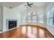 Living room with hardwood floors, fireplace, and vaulted ceiling at 6702 S Ivy Way # A1, Centennial, CO 80112