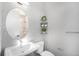 Clean bathroom with a floating sink and a large mirror at 5018 S Prince Pl, Littleton, CO 80123