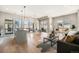 Open living room with hardwood floors, modern furniture, and large windows at 5018 S Prince Pl, Littleton, CO 80123