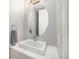 Modern powder room with an oval mirror and a floating vanity at 5018 S Prince Pl, Littleton, CO 80123
