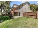 A spacious backyard features a deck, patio, and green grass at 6449 S Jamaica Cir, Englewood, CO 80111