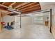 The unfinished basement provides flex space with natural light from a window at 6449 S Jamaica Cir, Englewood, CO 80111