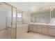 The bathroom features a tub and shower with gold trim, as well as a large vanity with double sinks at 6449 S Jamaica Cir, Englewood, CO 80111